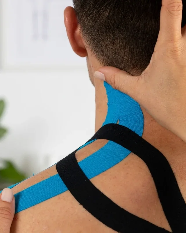 Elastic kinesiology tape applied along a patient's shoulder
