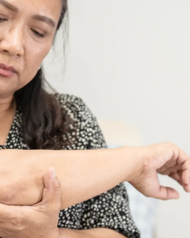 Occupational therapist guiding hand and wrist rehabilitation exercises