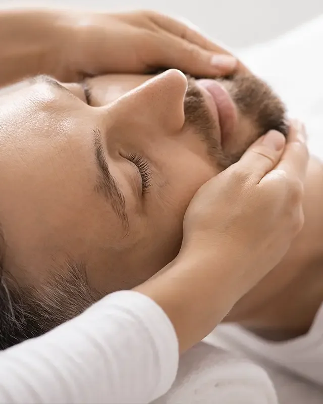 Therapist guiding a patient through jaw and neck retraining exercises